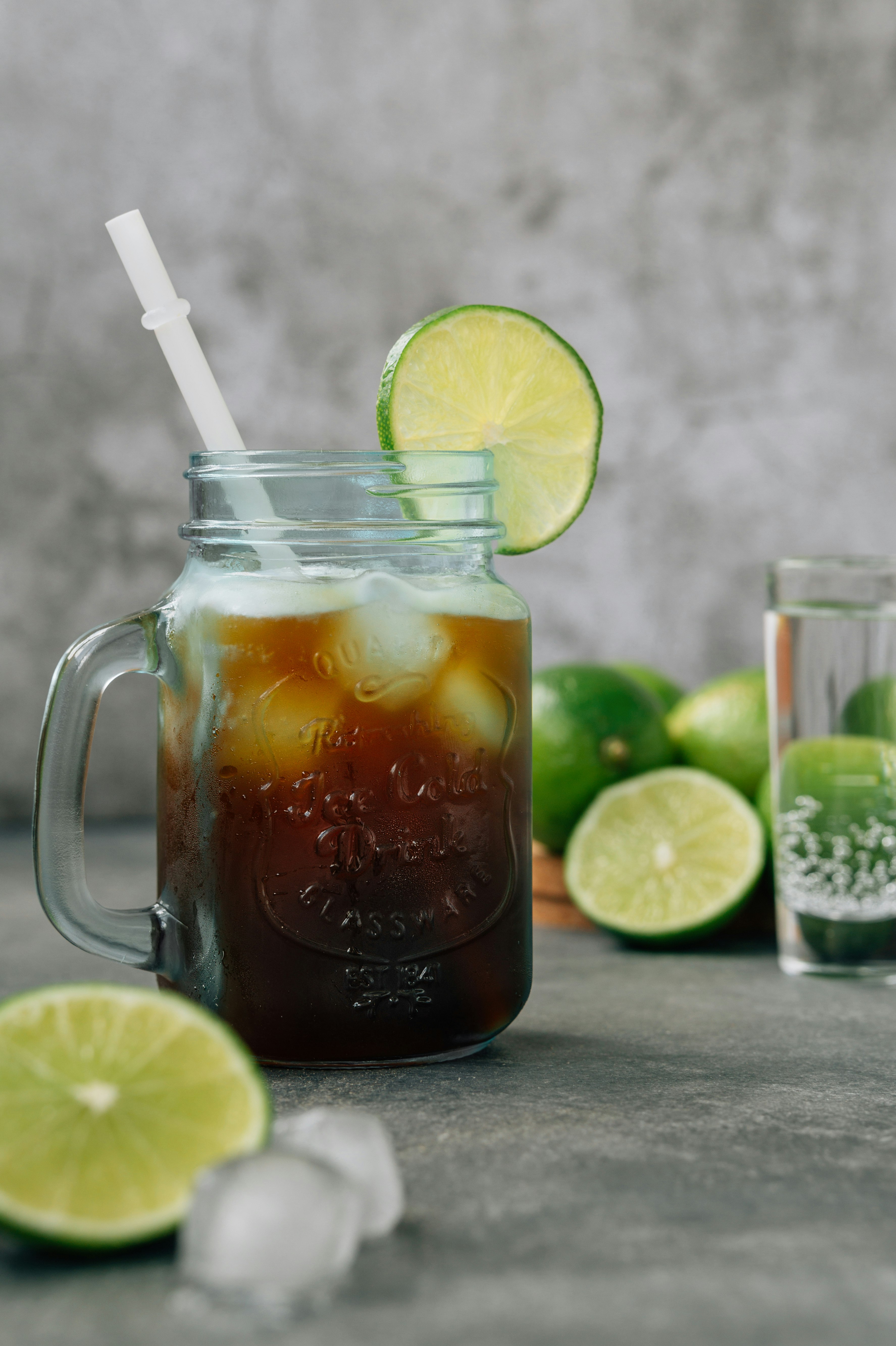 clear glass mug with brown liquid and sliced lemon